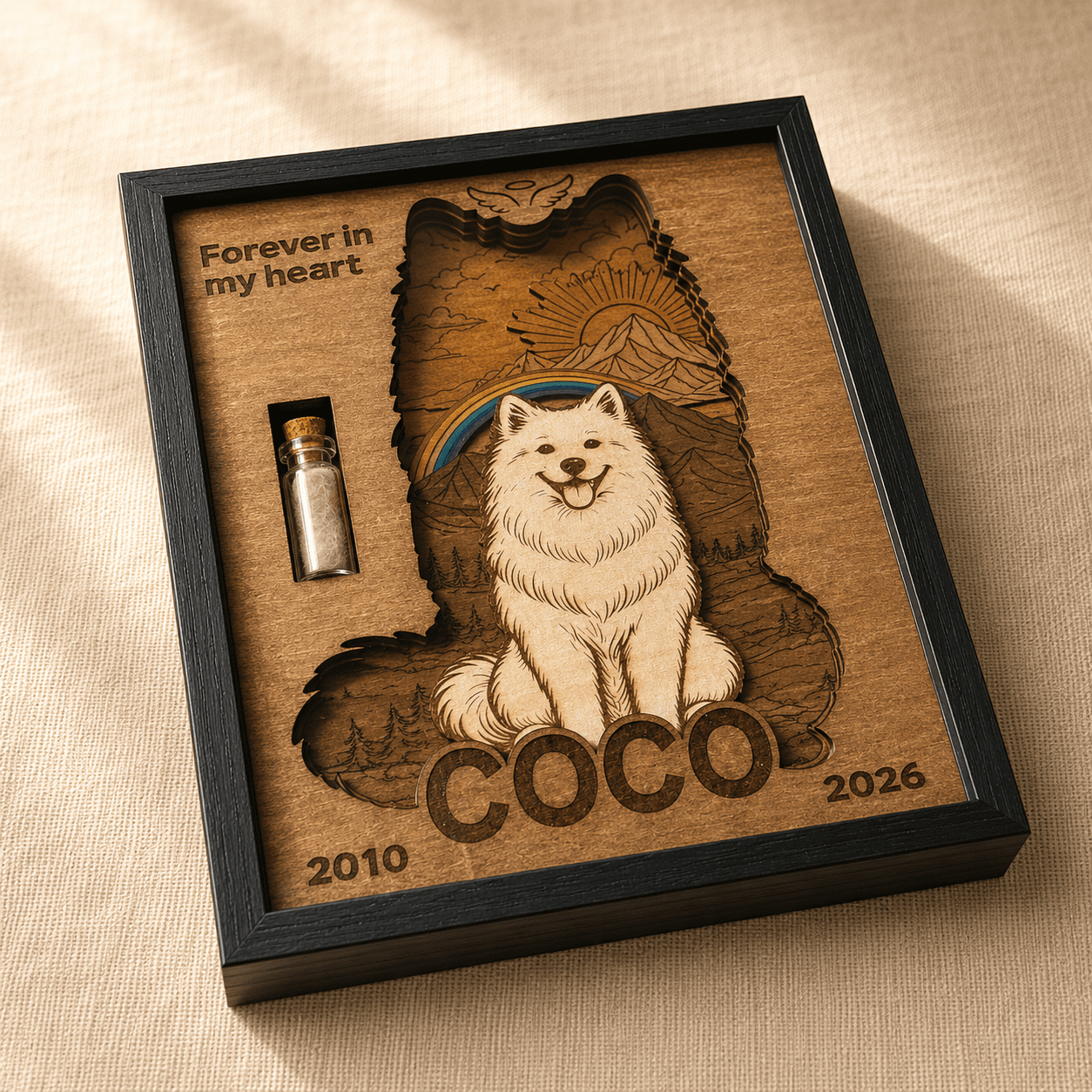 Close-up angled view of a personalized wooden pet memorial shadow box featuring a white dog portrait, layered rainbow bridge scenery, and a glass fur keepsake vial.