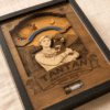 Close-up angled view of a handcrafted personalized wooden pet memorial shadow box with engraved portrait, rainbow bridge design, and keepsake vial compartment.