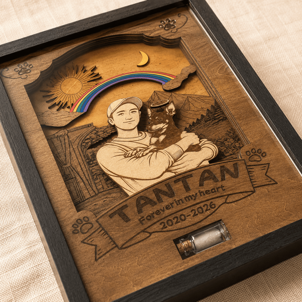 Close-up angled view of a handcrafted personalized wooden pet memorial shadow box with engraved portrait, rainbow bridge design, and keepsake vial compartment.