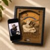Personalized wooden pet memorial shadow box displayed beside the original reference photo on a smartphone, showing custom portrait engraving transformation.