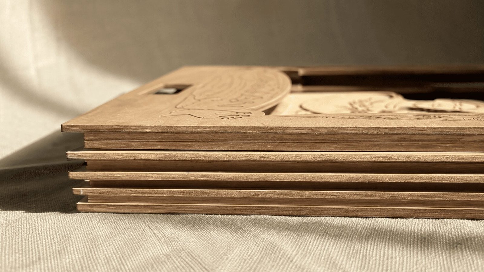Close-up side profile of layered wooden pet memorial shadow box panels showing the depth and multi-layer craftsmanship of the handmade design.