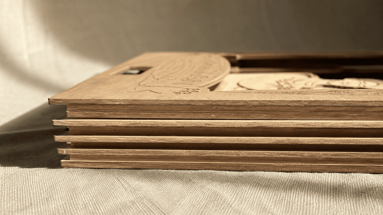 Close-up side profile of layered wooden pet memorial shadow box panels showing the depth and multi-layer craftsmanship of the handmade design.