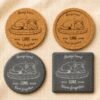 Comparison of personalized pet memorial coaster options in cork and slate materials with round and square shapes on neutral linen fabric.