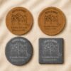 Comparison of personalized pet memorial coaster materials and shapes including round and square slate coasters alongside cork coaster options displayed on soft cream linen fabric.