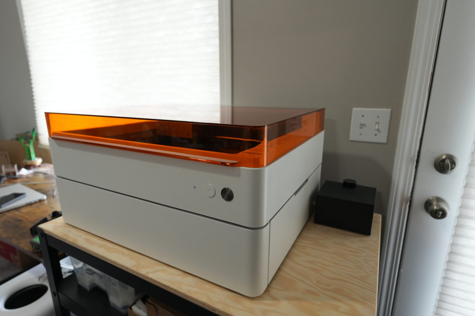 xTool M1 Ultra laser machine placed on a wooden workstation inside a home craft studio.