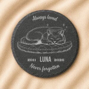 Personalized round slate cat memorial coaster featuring an engraved sleeping cat portrait, pet name Luna, memorial years 2011–2026, and the quote “Always Loved, Never Forgotten,” displayed on a soft linen background.