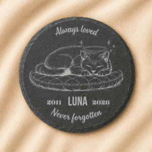 Personalized round slate cat memorial coaster featuring an engraved sleeping cat portrait, pet name Luna, memorial years 2011–2026, and the quote “Always Loved, Never Forgotten,” displayed on a soft linen background.