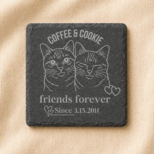 Square black slate coaster engraved with custom portraits of Coffee and Cookie, featuring the phrase “Friends Forever” and a personalized date, displayed on a cream linen background.
