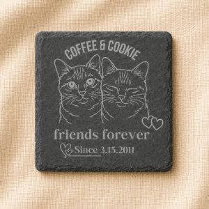 Square black slate coaster engraved with custom portraits of Coffee and Cookie, featuring the phrase “Friends Forever” and a personalized date, displayed on a cream linen background.