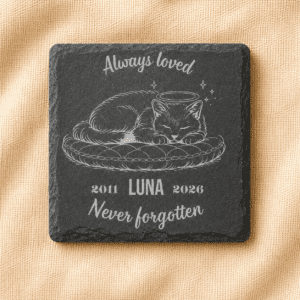 Personalized square slate pet memorial coaster featuring an engraved sleeping cat with angel halo, custom name Luna, memorial years 2011–2026, and the message “Always Loved, Never Forgotten,” displayed on a soft cream linen background.