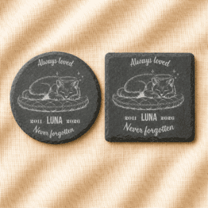 Personalized pet memorial slate coasters shown in both round and square shapes, featuring an engraved sleeping cat with angel halo, custom name Luna, memorial years 2011–2026, and the remembrance message “Always Loved, Never Forgotten,” displayed on a soft cream linen background.