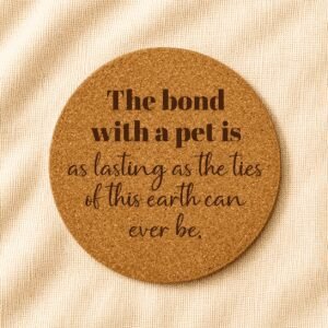 Round cork coaster featuring an engraved sentimental pet quote in mixed serif and script typography on a warm cream linen background.